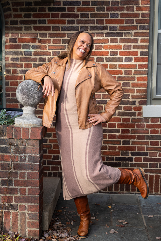 Brenda standing by brick wall